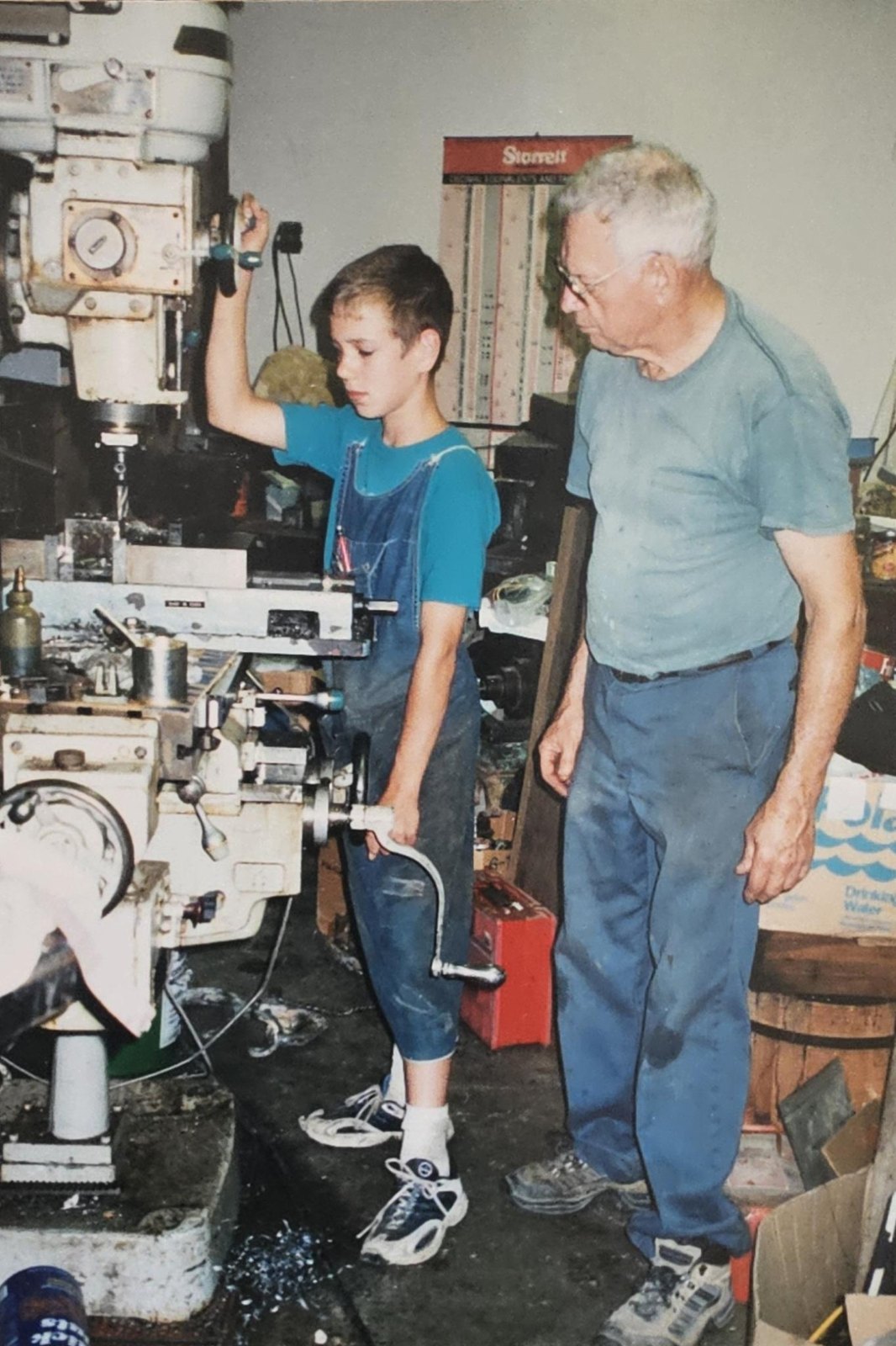 Don Landes alongside a young family member at a milling machine, from the Landes Family Archive